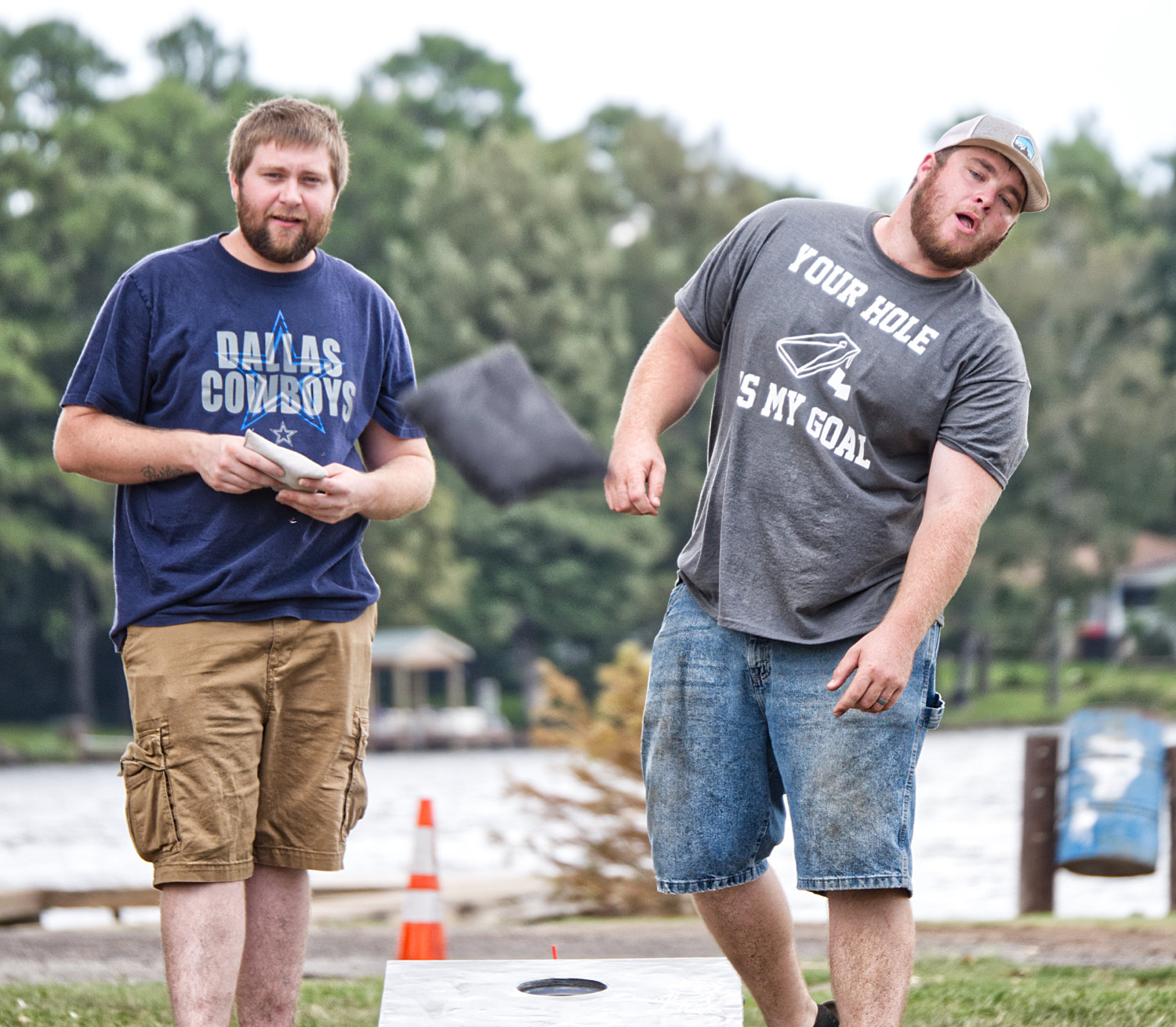 Competing in the cornhole tournament are Eric Baker, left, and Garrett Driskill.